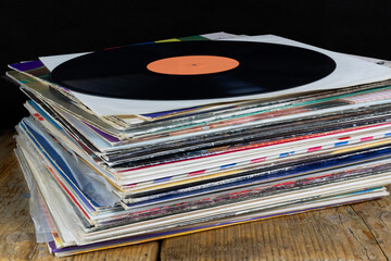  Stack of Vinyl Records on Wooden Surface