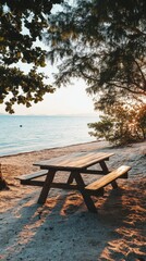 A wooden table sits on the edge of a sandy beach, perfect for outdoor gatherings or a unique picnic spot