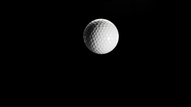 Rotating and Flying White Golf Ball on Black Background . Filmed on High Speed Cinematic Camera at 1000 fps