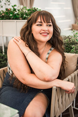 Young plus size woman with long hair in top and skirt