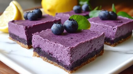 Decadent blueberry cheesecake on white marble. Vibrant purple berries and a lemon add a pop of color. Soft, blurred background