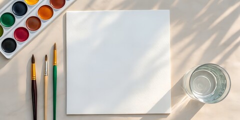 Creative watercolor setup with vibrant colors, brushes, paper, and water ready for artistic expression