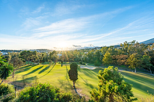 a sunset landscape image overlooking a mediterranean golf course in Spain