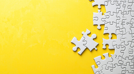 Obraz premium White puzzle piece on a vibrant yellow background, symbolizing the final step in completing a business plan. Perfect for marketing and strategy concepts.