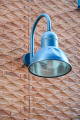Close up of blue color lantern on red brick textured wall, Roterman city district, Tallinn, Estonia, Europe