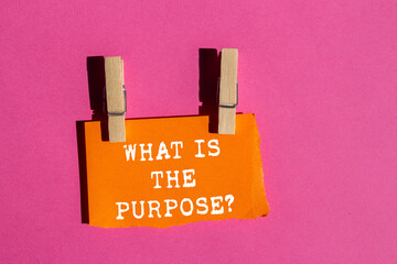 What is the purpose message written on ripped torn orange paper on pink background. Conceptual what...