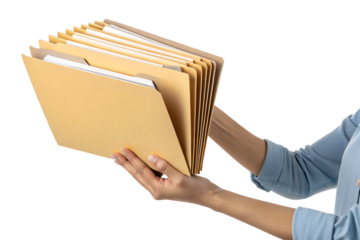 A person holds several manila file folders while organizing documents