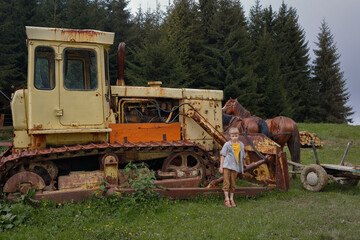 Obraz premium a village boy stands near a combine
