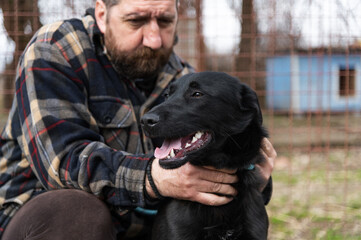 Volunteer from the dog shelter with his dog during obedience training and socialization