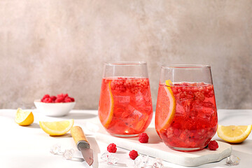 Refreshing summer homemade lemonade cocktail, mojito with raspberry, currant, mint and lemon, weight loss concept, detox water with fruit flavor on light background. healthy and natural food,