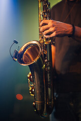 Saxophonist playing saxophone on stage during live performance
