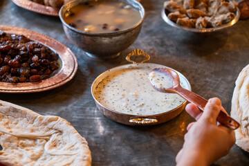 Traditional Turkish yogurt soup (Ayranli Corba) served on a rustic dining table