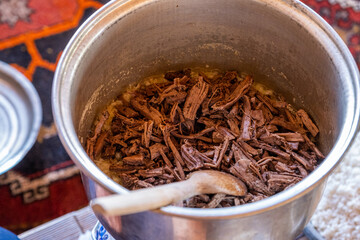 Meat being added into pot for cooking Divrigi Pilavi, Turkish specialty