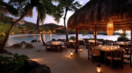 Romantic resort dinner setup on the beach, candlelit tables arranged under a thatched-roof gazebo.