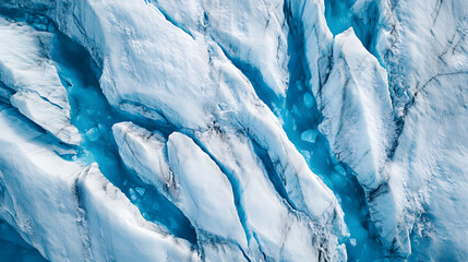 Top-Down Drone View of Icy Glacier Landscape with Dramatic Crevasses and Blue Ice Patterns