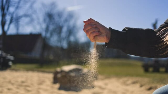 Stunning video capture the moment of hands releasing warm sand, preserving cherished beach memories that evoke nostalgia and the freedom of golden summer sunlight