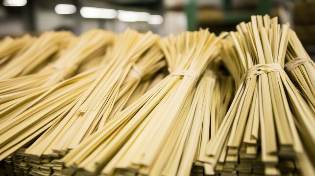 Evenly cut bamboo strips laid out in parallel, ready for further processing
