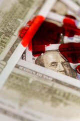 Blood Stains on Dollar Bills.Bloody criminal finance.Drops of blood fall on dollars.Benjamin...
