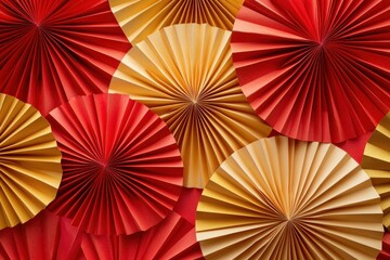 Festive paper fans in red and gold.  Layered circular paper decorations.  Vibrant colors create a celebratory backdrop