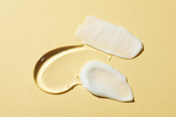 Body cream and gel on beige background, flat lay