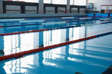 Obraz premium Swimming pool with clean water and lane dividers indoors
