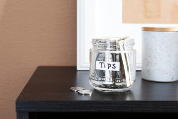 Glass jar with tips on wooden cabinet indoors