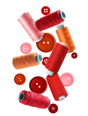 Spools of colorful sewing threads and buttons falling on white background
