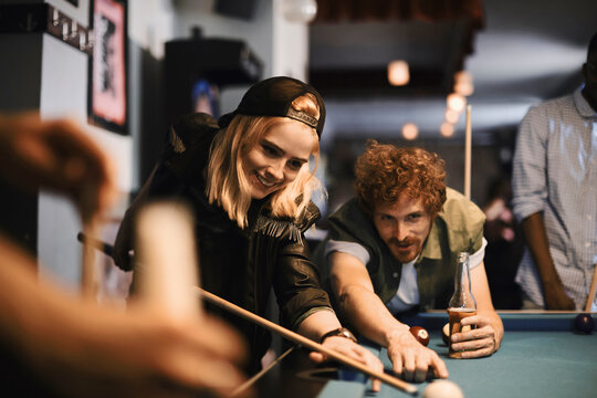 Young people playing pool in a club