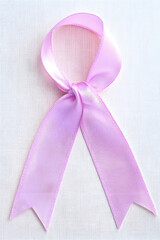 Light pink awareness ribbon on white background