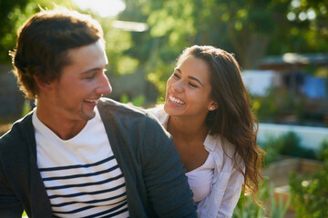 Couple, home and happy in garden on break with fun, laughing and bonding for love in Spain. People, relationship and outside with smile for nature at backyard for support, care and trust as lovers