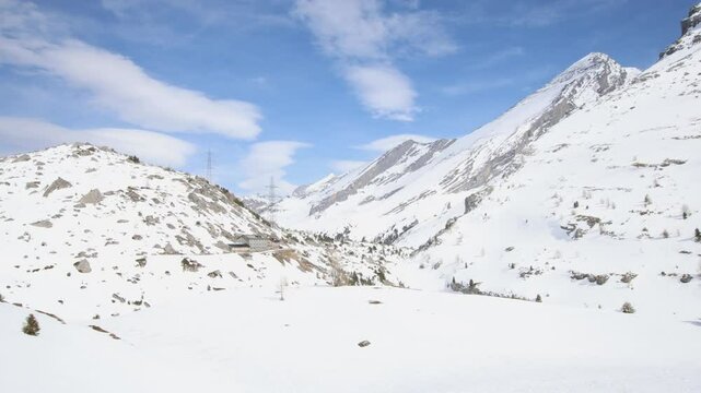 Winter mountain pass with hotel near Gemmi pass in Swiss alps, landscape establisher