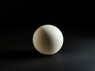 Single white sphere on dark background, dramatic lighting.