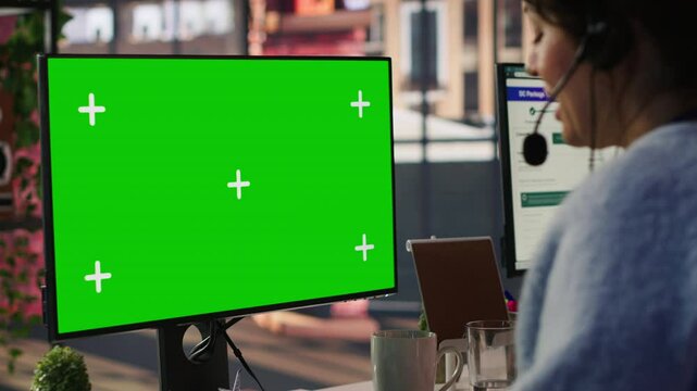 Call center agent helping customers regain access to accounts using green screen mockup PC. Employee in customer center assisting clients needing help, working on chroma key computer, camera A