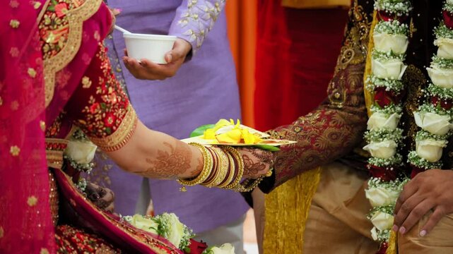  Indian Hindu Rituals that performed during holy wedding ceremony. Bride and groom holding each others hands. Close up shot of part of wedding ceremony