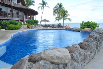 Obraz premium Tropical resort pool, ocean view