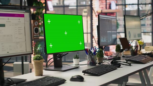 Green screen PC monitors in empty call center office where unsatisfied customers call to solve technical problems. Mockup computer displays in customer support workspace, panning shot