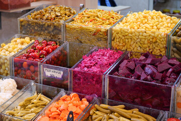 Colorful display of fresh vegetables and pickled goods at market