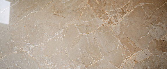 Matte beige marble texture with subtle white veining and earthy mineral patterns, natural stone surface background  

