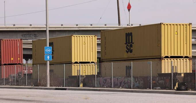 Compton, California, USA - April 2, 2025: An intermodal stack freight train loaded with containers passes towards the port of Los Angeles.