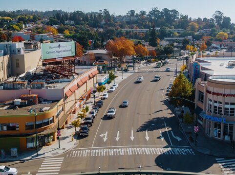 An aerial view of a street in Hayward, shows cars driving on a sunny day. The photo captures the urban landscape and daily life. Downtown, Hayward, California, USA. 24 November 2024