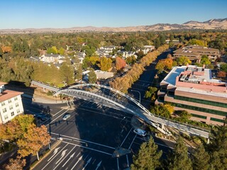 Aerial view of Walnut Creek, California, USA, featuring a pedestrian bridge connecting  to the...