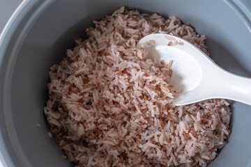 Thai red jasmine rice. Rice scoop in rice cooker.