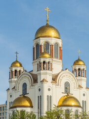 The golden domes of the Christian church in sunset light.