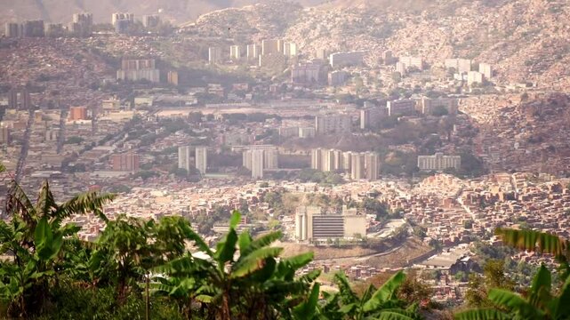 Wide aerial view of Caracas, Latin american city framed by an artisanal crop from El &Aacute;vila mountain National Park.