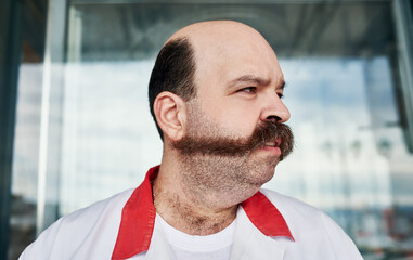 Mustache, city and face of man with facial hair by shop window for butcher job, career and working....