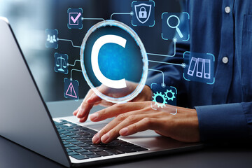 Copyright management solutions. Digital rights management DRM. Intellectual property and content protection. Man using laptop computer to manage content with technology.