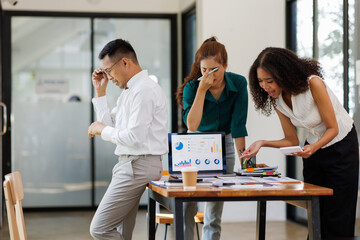  teamwork of tired young business with documents tax laptop computer in office. Sad, unhappy, Worried, Depression, or employee life stress concept
