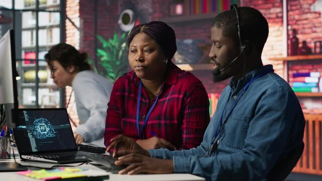 Call center manager teaching intern how to use AI to enhance customer interactions. Team leader in customer service office explaining trainee how to use artificial intelligence, camera A