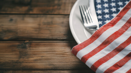 festive table setting featuring plate with fork and knife, adorned with American flag napkin, evokes sense of celebration