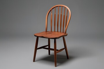 Obraz premium A classic wooden chair isolated on a gray background.